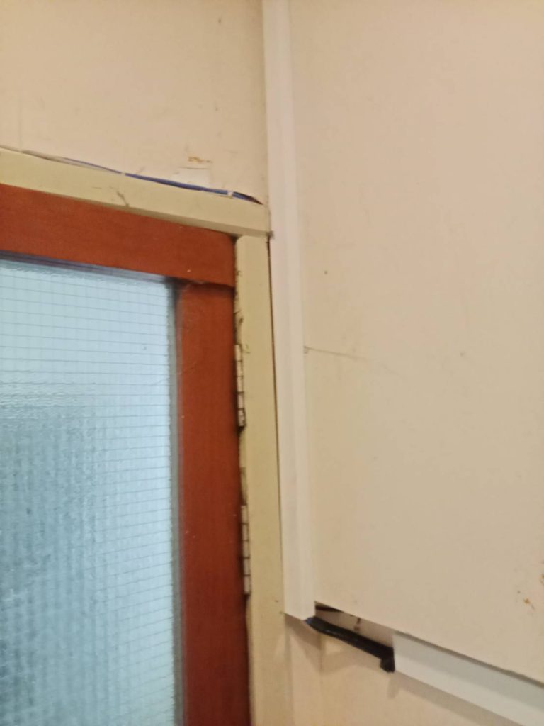 Electrical conduit installed along the wall near a door frame.